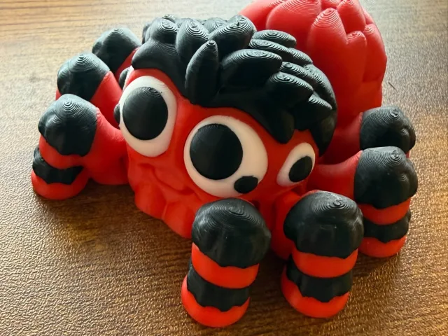 Red, black, and white articulated spider 3D print